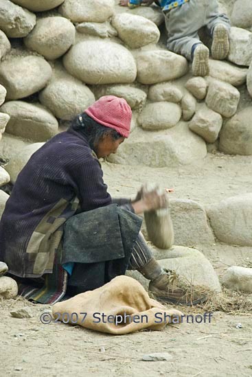 woman grinding grain graphic